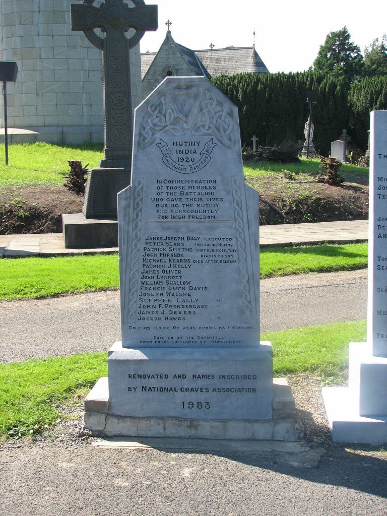 A headstone in Glasnevin Cemetery, Dublin. It has faint writing on it and lists fifteen men who were participants of the mutiny of the Connaught Rangers in 1920.